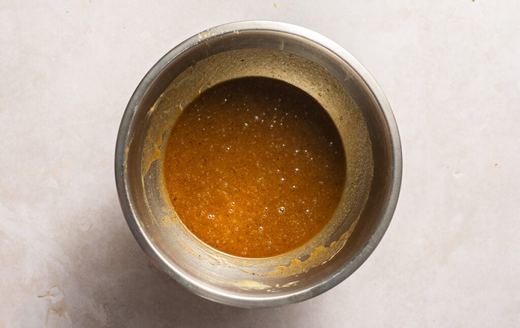 sugar, brown butter and vanilla extract mixed in a bowl