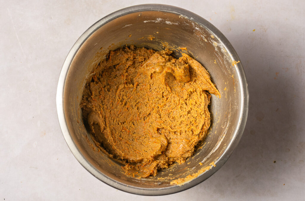 carrot cake cookie dough in a stainless steel bowl