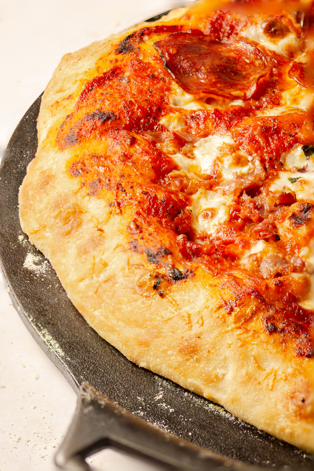 homemade pizza on a cast iron pan