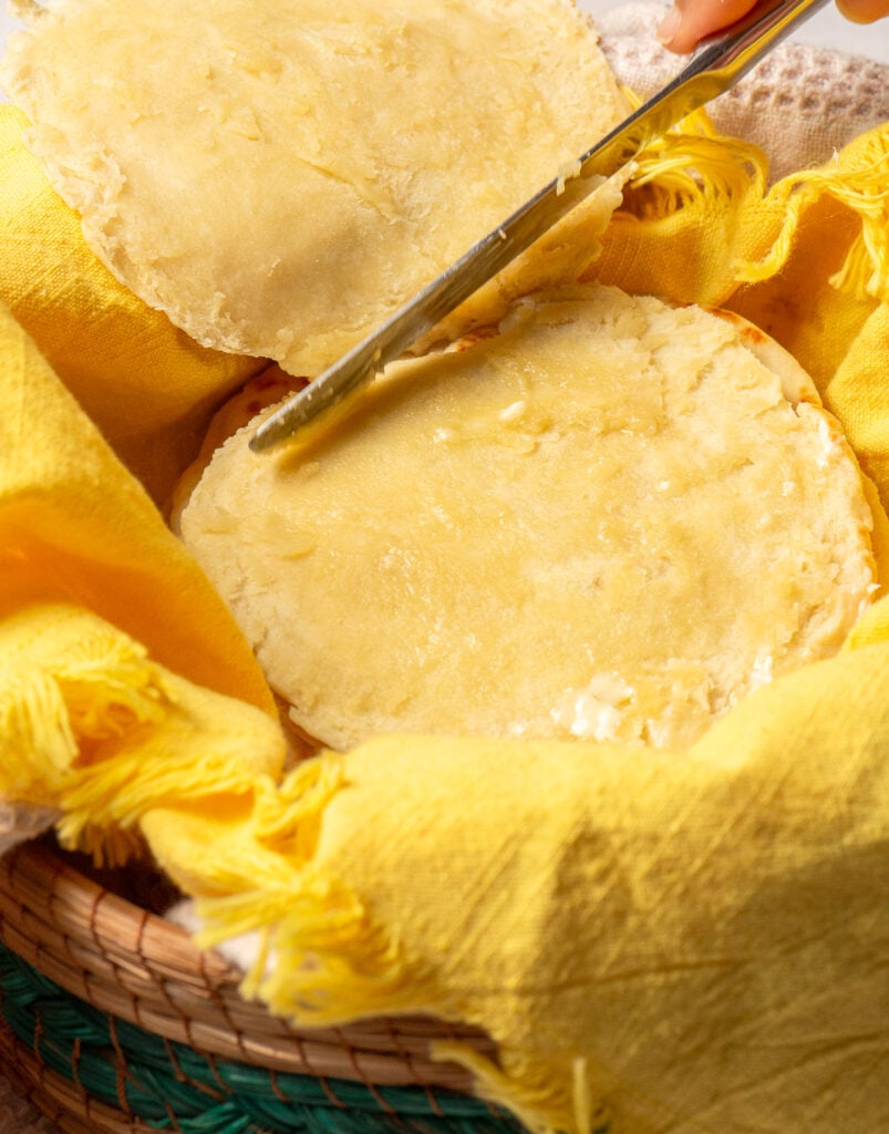 spreading butter on sliced Belizean flour tortillas