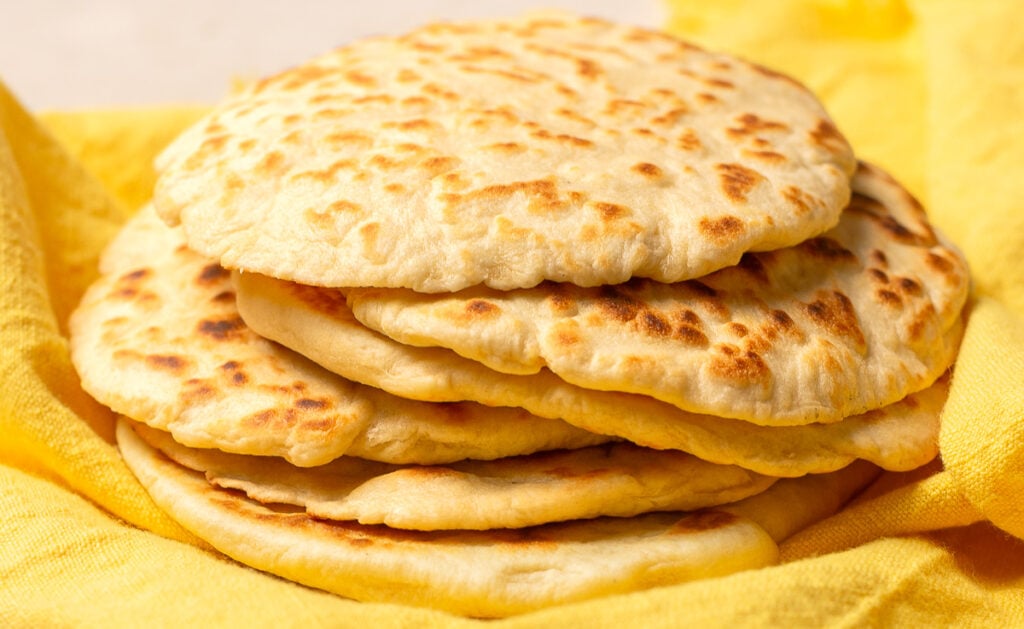 Belizean flour tortillas wrapped in kitchen towel