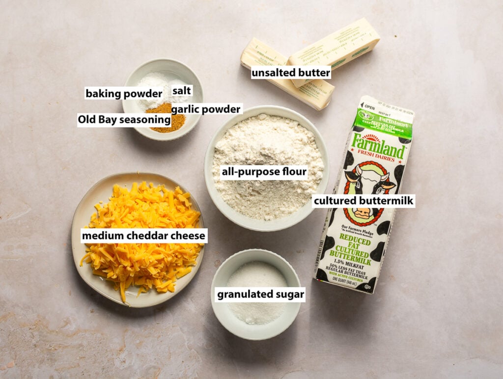 ingredients for cheddar bay biscuits - all-purpose flour, cheddar cheese, unsalted butter, cultured buttermilk, Old Bay seasoning, baking powder, salt, garlic powder, granulated sugar