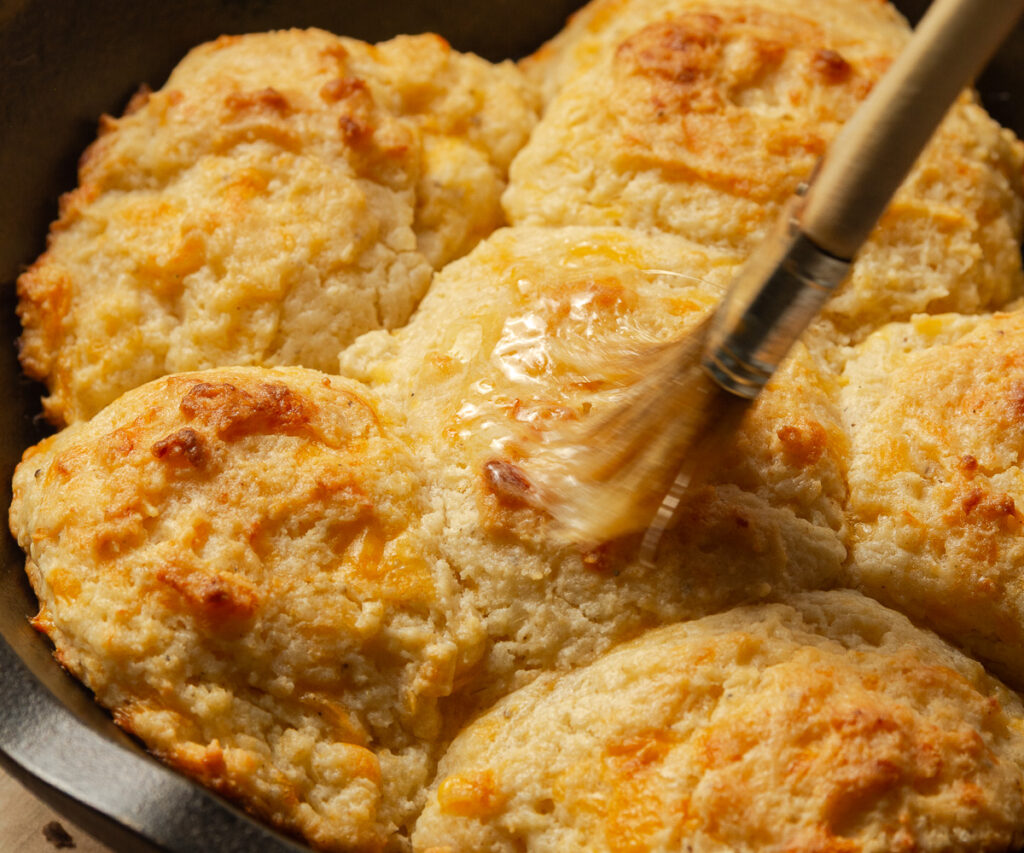 brushing cheddar bay biscuits with melted butter