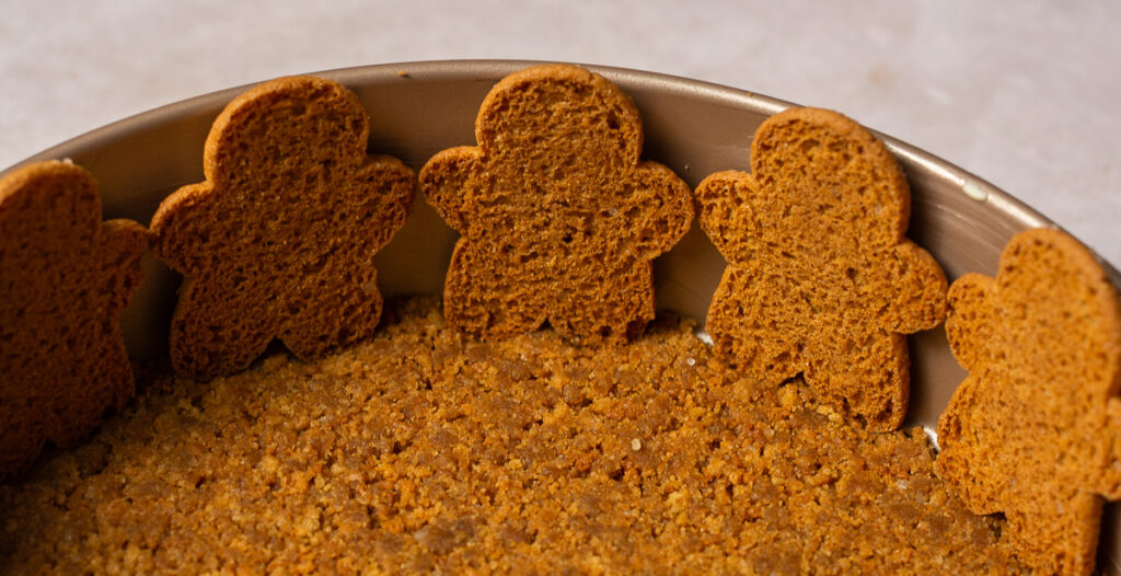 springform pan lined with whole gingerbread men cookies