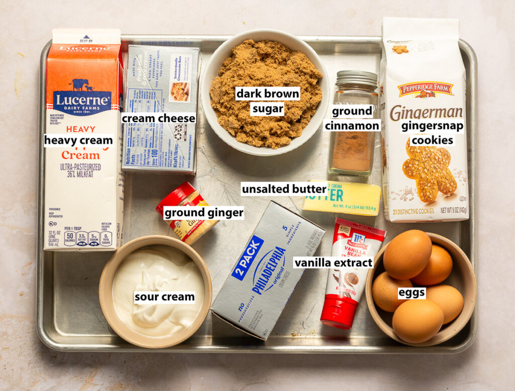 ingredients for a gingerbread cheesecake with brown sugar whipped cream - cream cheese, sour cream, dark brown sugar, gingersnap cookies, ground ginger, ground cinnamon, eggs, unsalted butter, vanilla extract & heavy cream