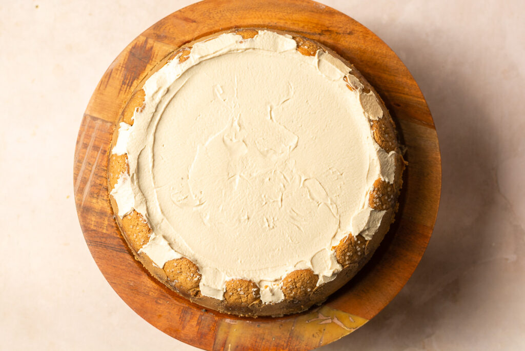 cheesecake topped with brown sugar whipped cream