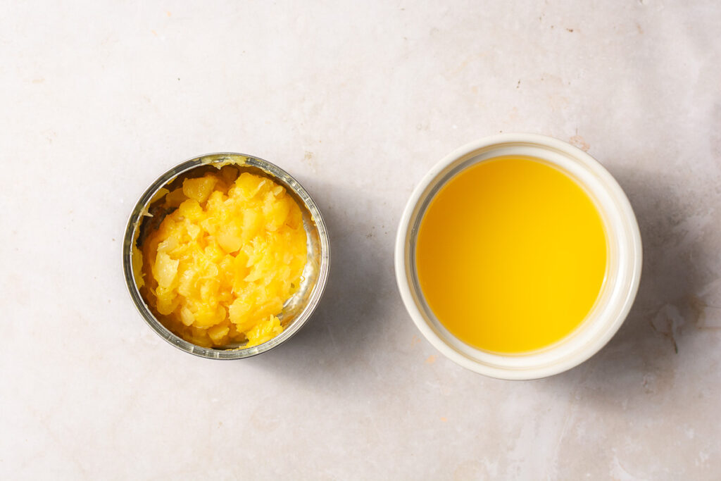 drained can of crushed pineapples and the drained pineapple juice in a bowl