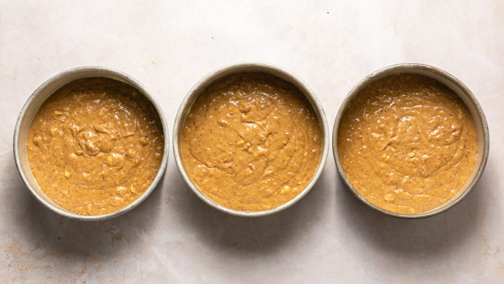 hummingbird cake batter in three 8-inch cake pans