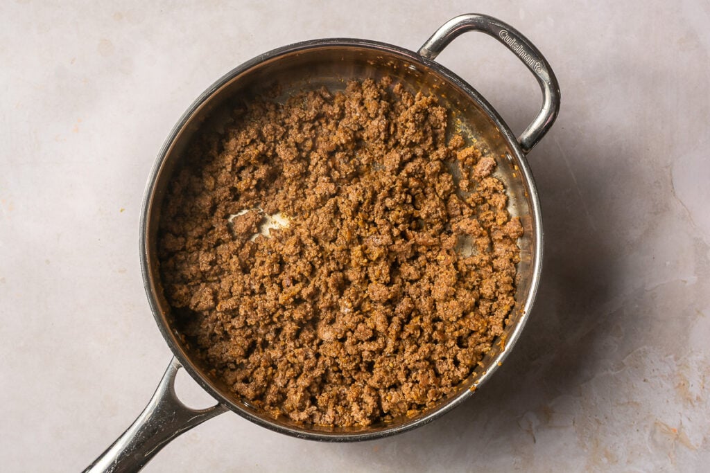 browned ground beef in a pan