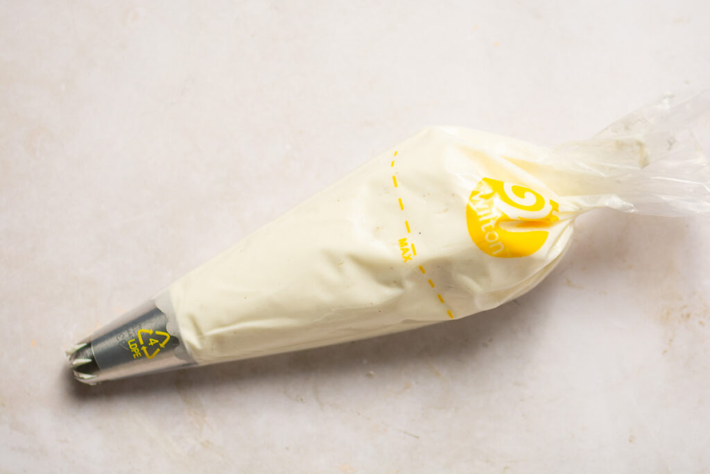 whipped cream in a piping bag with piping tip