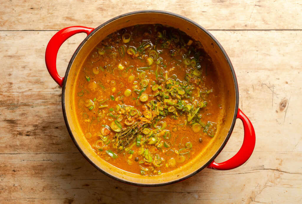 dutch oven deglazed with chicken broth for Jamaican curry chicken