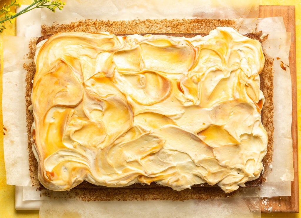 banana caramel sheet cake on parchment paper