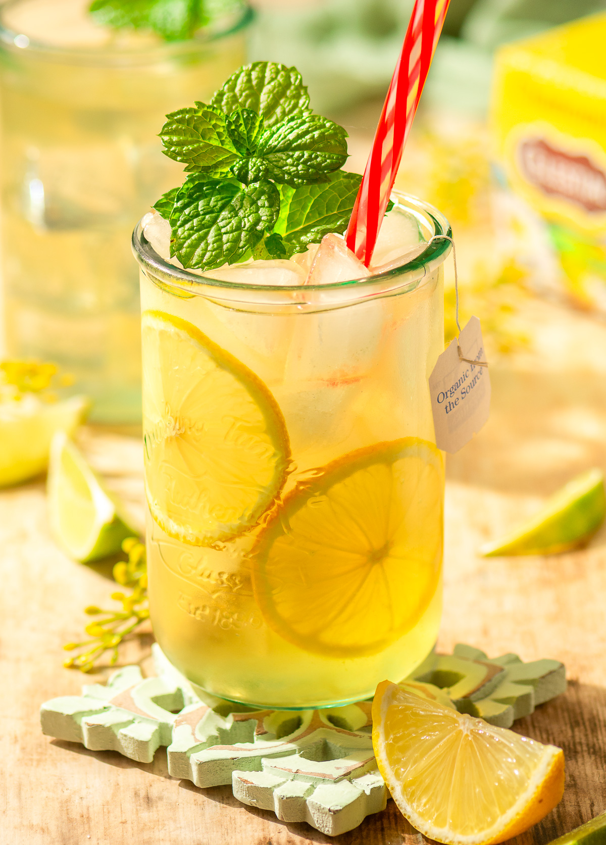 chamomile iced tea in a glass with lemon slices and mint garnish
