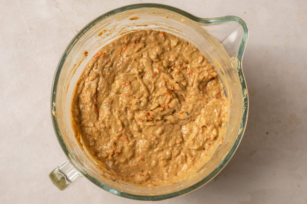 carrot cake batter in a glass mixing bowl