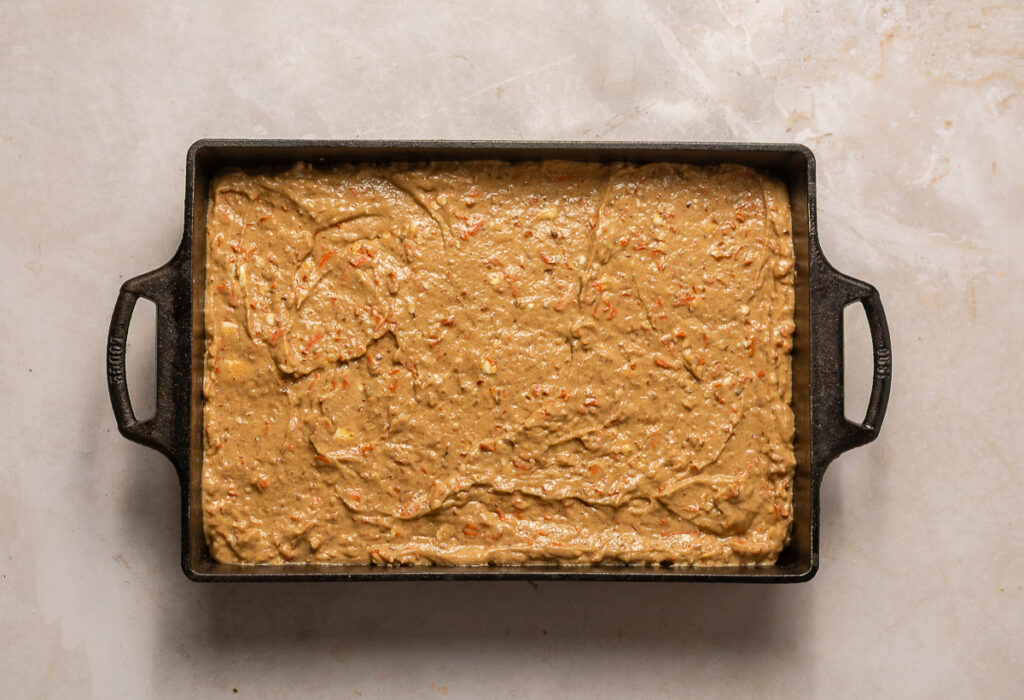 carrot cake batter in a prepared 9x13 baking dish