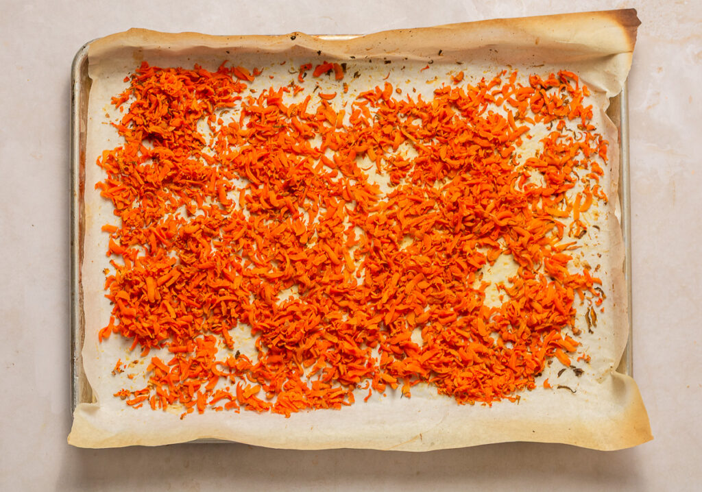 shredded carrots on a baking sheet after roasting