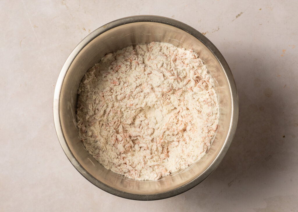 carrots, crushed pecans, all-purpose flour, baking soda and salt mixed in a stainless steel bowl