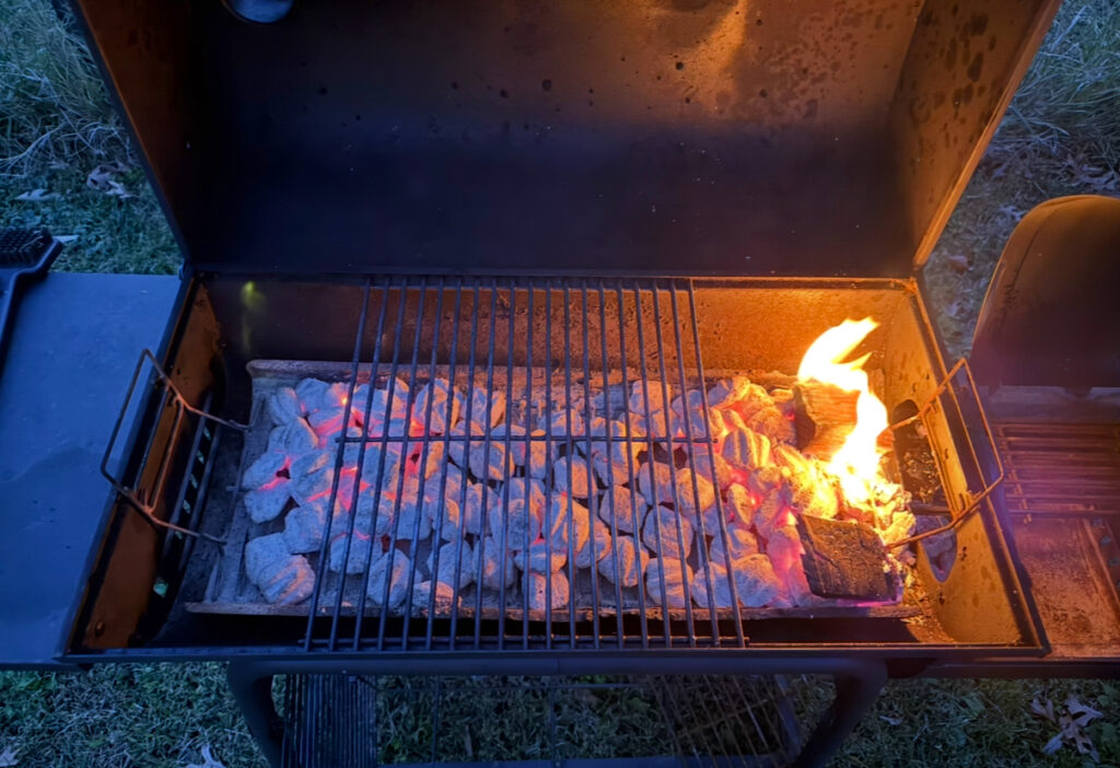 grill set up with hot coal and wood chunks