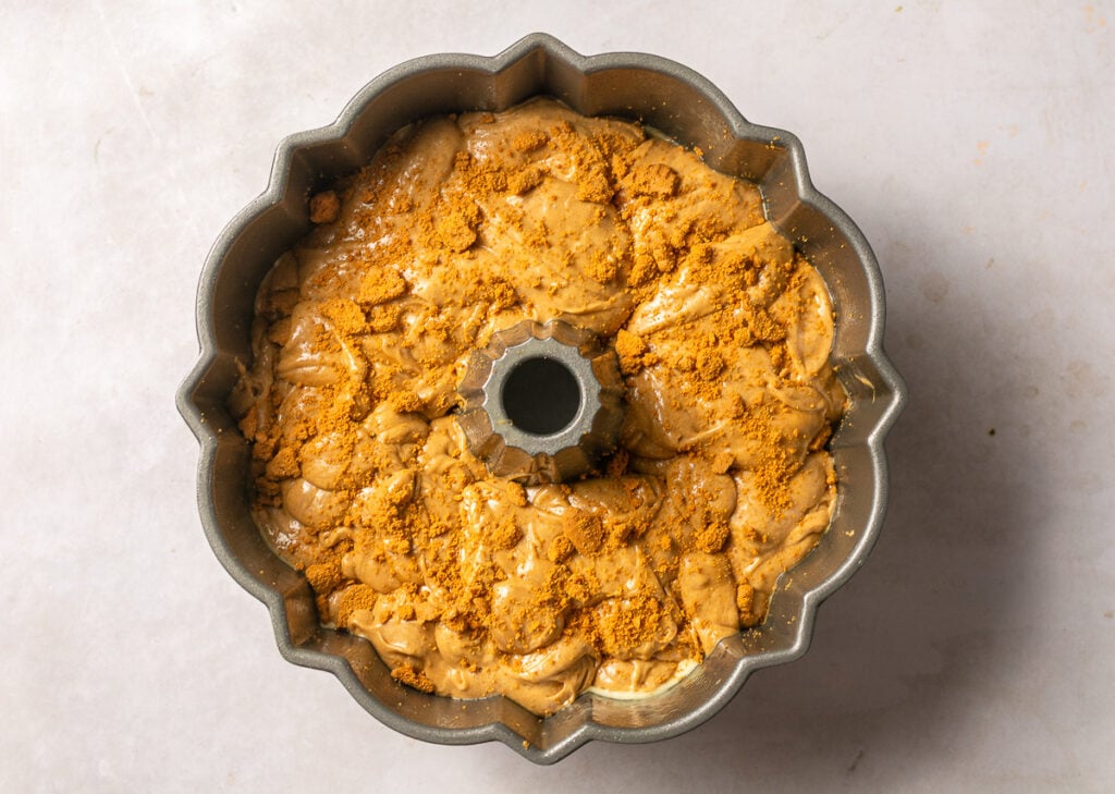 bundt cake pan filled with biscoff cookie butter cake batter 