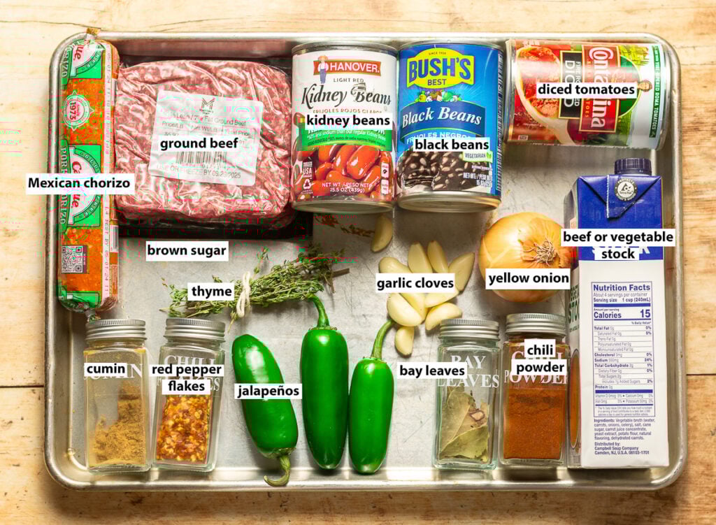 beef and chorizo chili ingredients - ground beef, Mexican chorizo, red kidney beans, diced tomatoes, beef stock, yellow onion, garlic cloves, thyme, brown sugar, cumin, red pepper flakes, jalapenos, Bay leaves, chili powder
