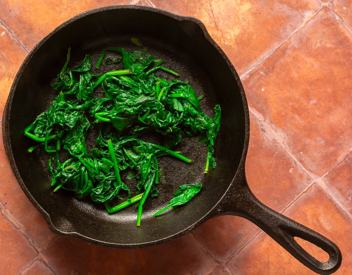 wilted spinach in cast iron pan