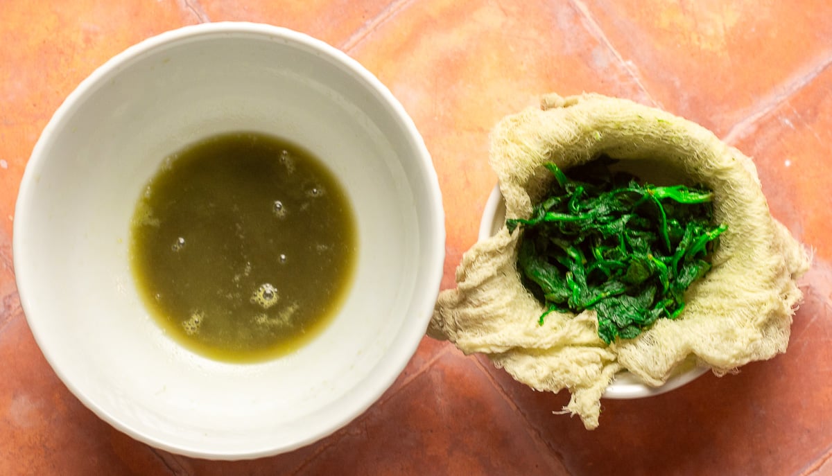 drained spinach in cheesecloth