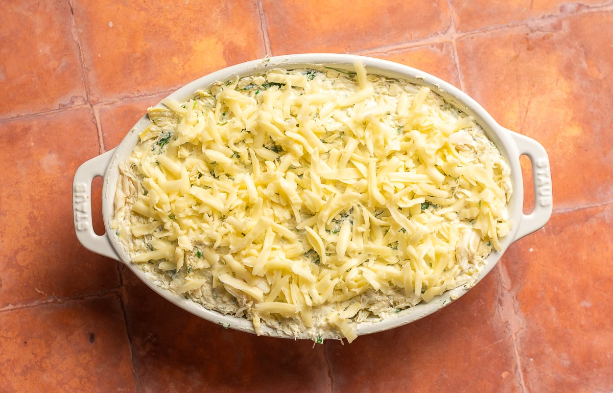 crab spinach artichoke dip mix in a baking dish