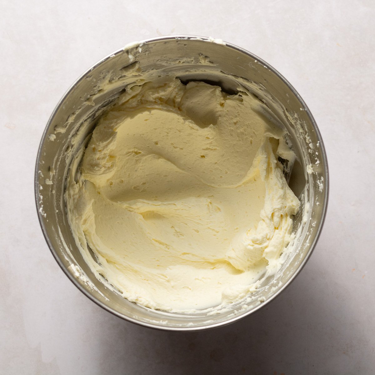 cream cheese and mascarpone cheese beat together in a bowl