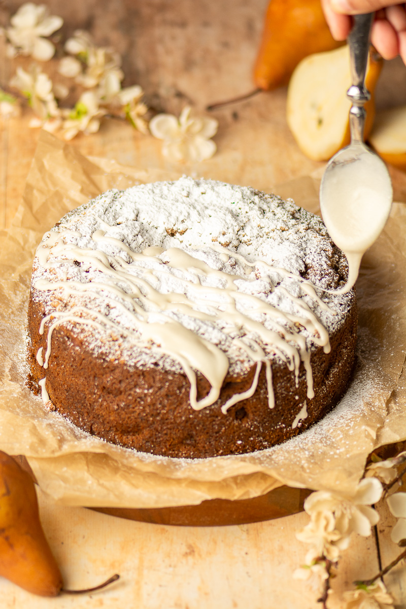 topping spiced pear crumb cake with vanilla glaze icing