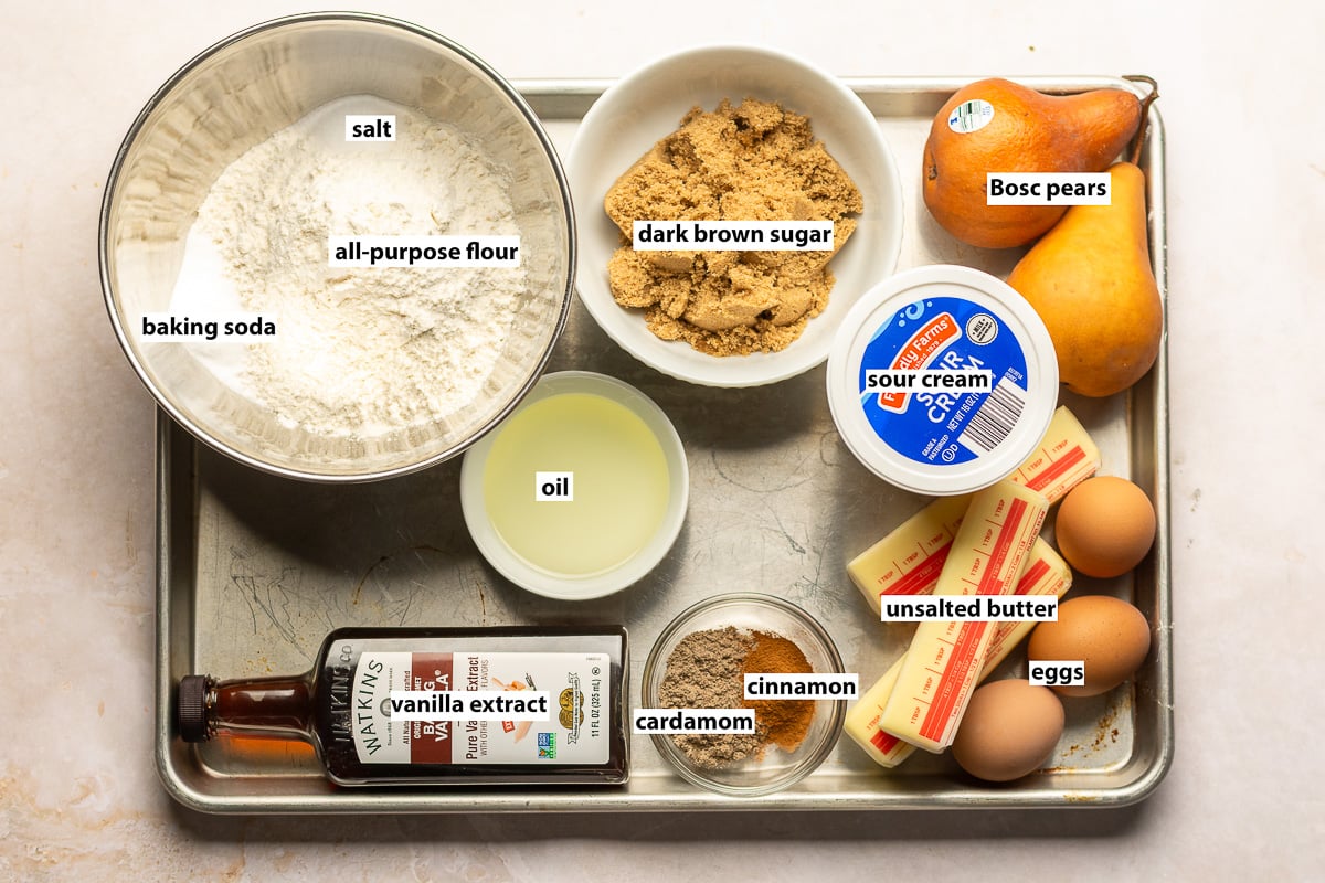 ingredients for spiced pear crumb cake - all-purpose flour, baking soda, salt, dark brown sugar, sour cream, oil, unsalted butter, Bosc pears, eggs, cinnamon, cardamom and vanilla extract