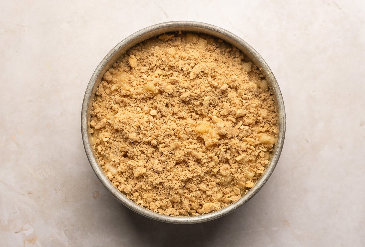 spiced pear crumb cake with pear and crumb topping ina cake pan