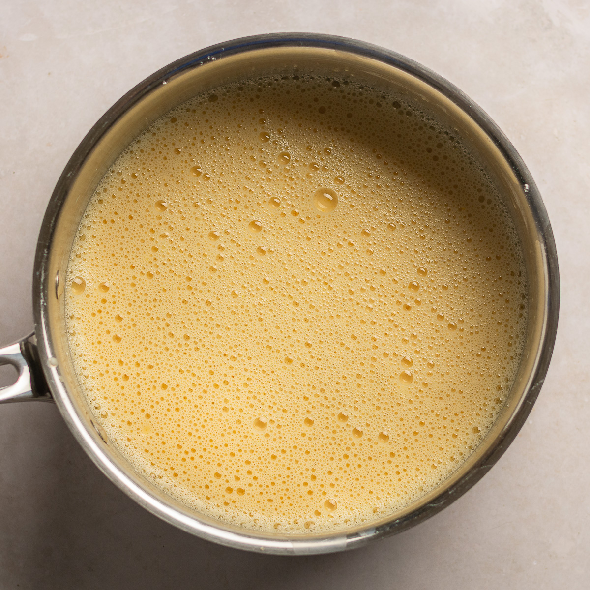 evaporated milk whisked with sugar, all-purpose flour, and egg yolks in a saucepan.