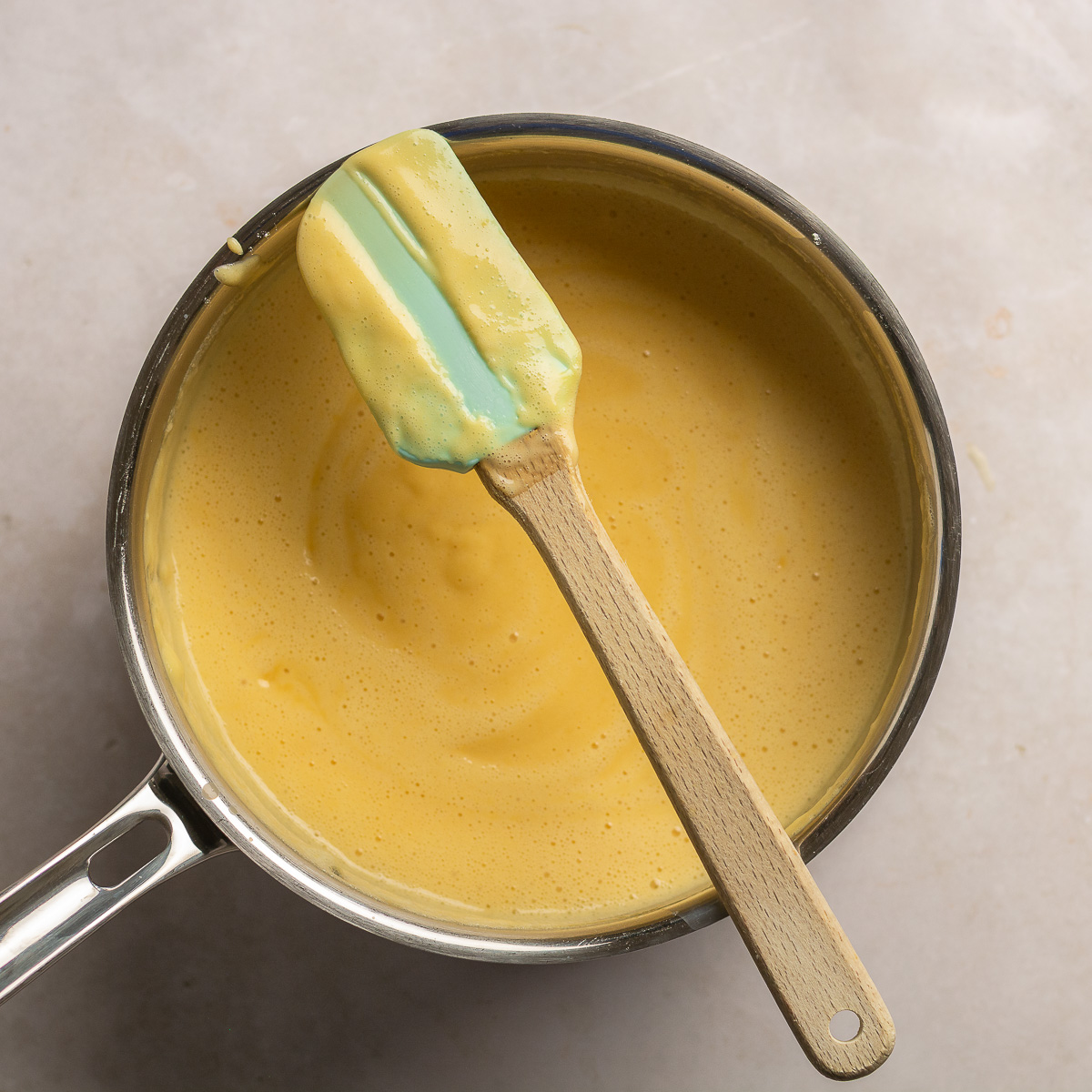 finished custard showing nappe consistency on a spatula.
