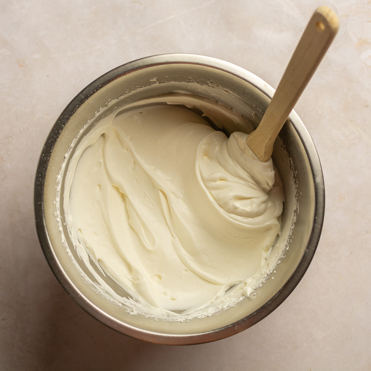 whipped cream in a stainless steel bowl