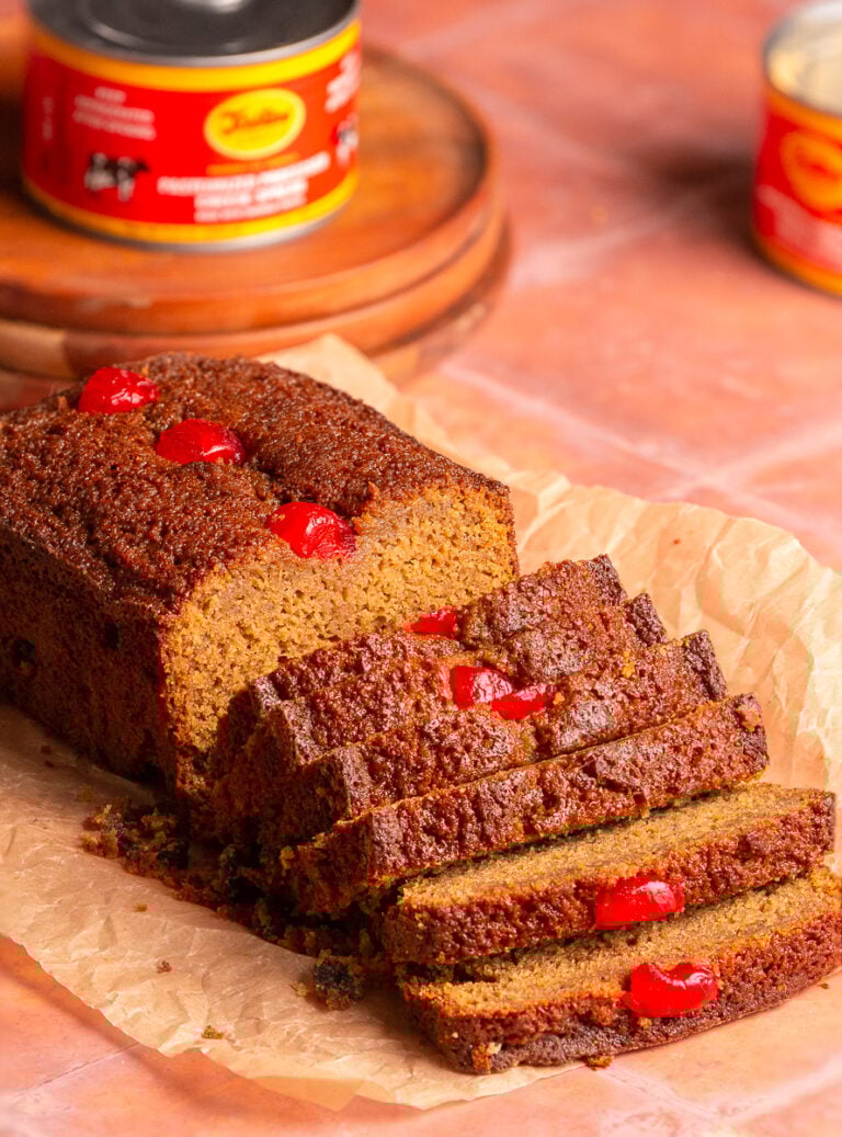 sliced Jamaican easter bun on parchment paper.