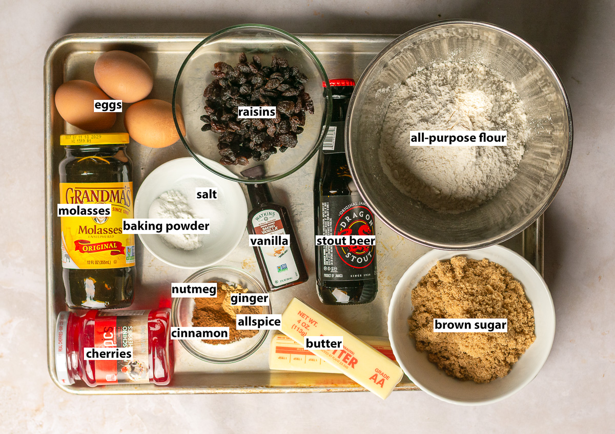 ingredients for Jamaican easter bun - all-purpose flour, dragon stout beer, eggs, butter, brown sugar, vanilla, cinnamon, nutmeg, allspice, ginger, baking powder, salt, molasses and Maraschino cherries.