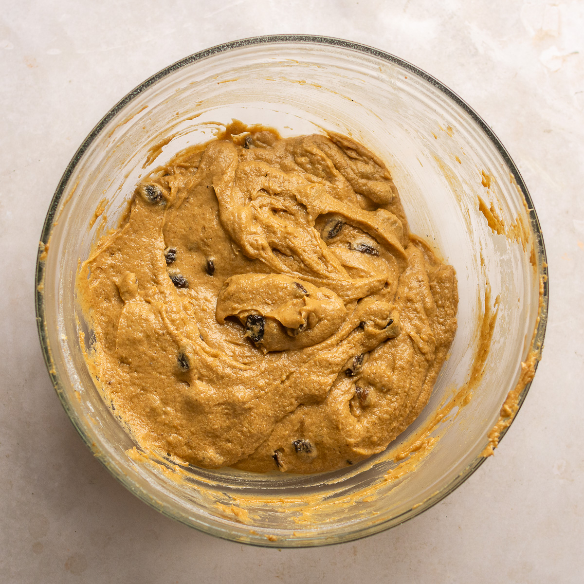 Jamaican easter bun batter in a glass mixing bowl.