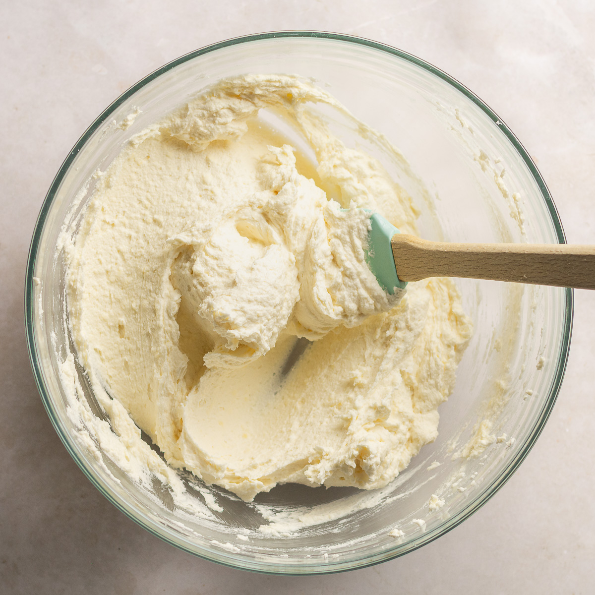 butter, oil, sugar, vanilla and coconut extract creamed together in a glass bowl.