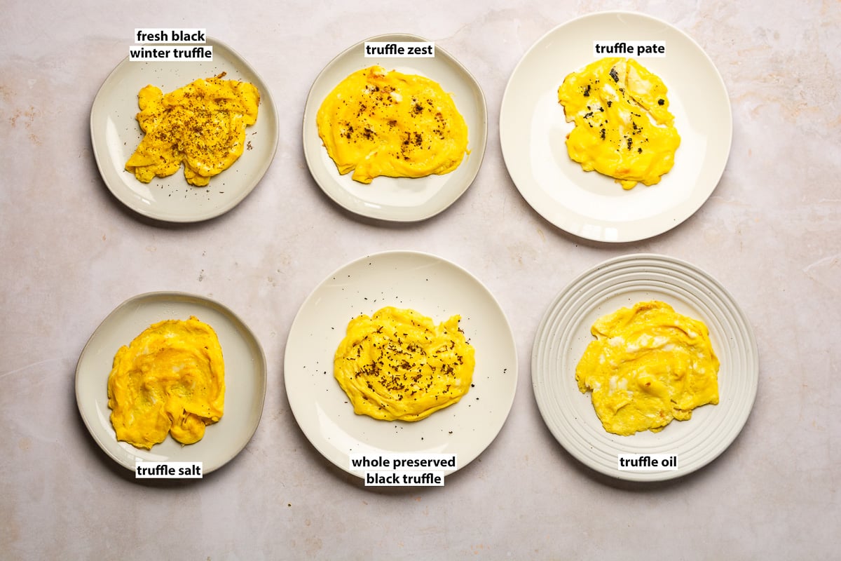 scrambled eggs on 6 different plates with 6 different truffle product toppings.