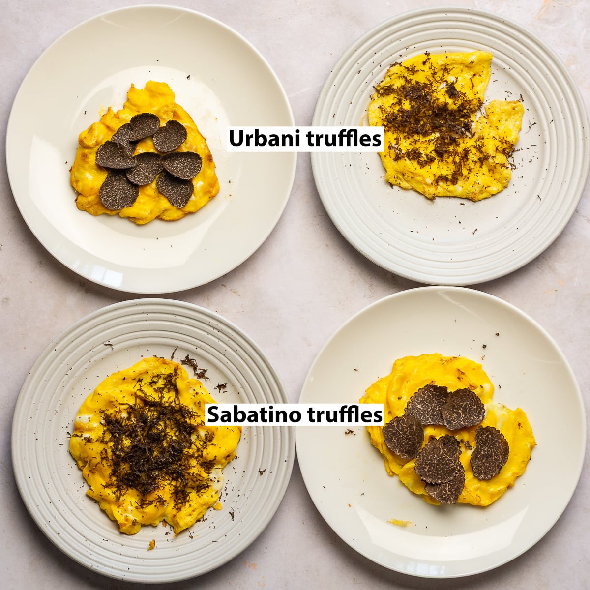 4 plates of scrambled eggs topped with grated and shaved truffles - 2 with Urbani truffles and 2 with Sabatino truffles.