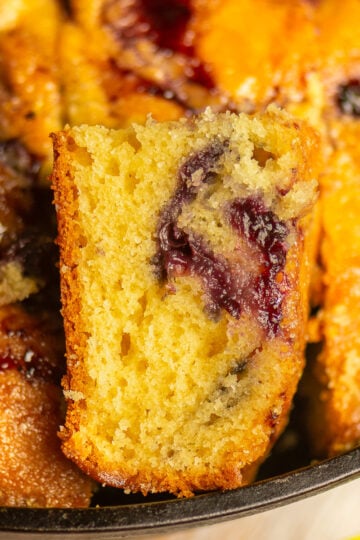 sliced blueberry cornbread in a skillet.