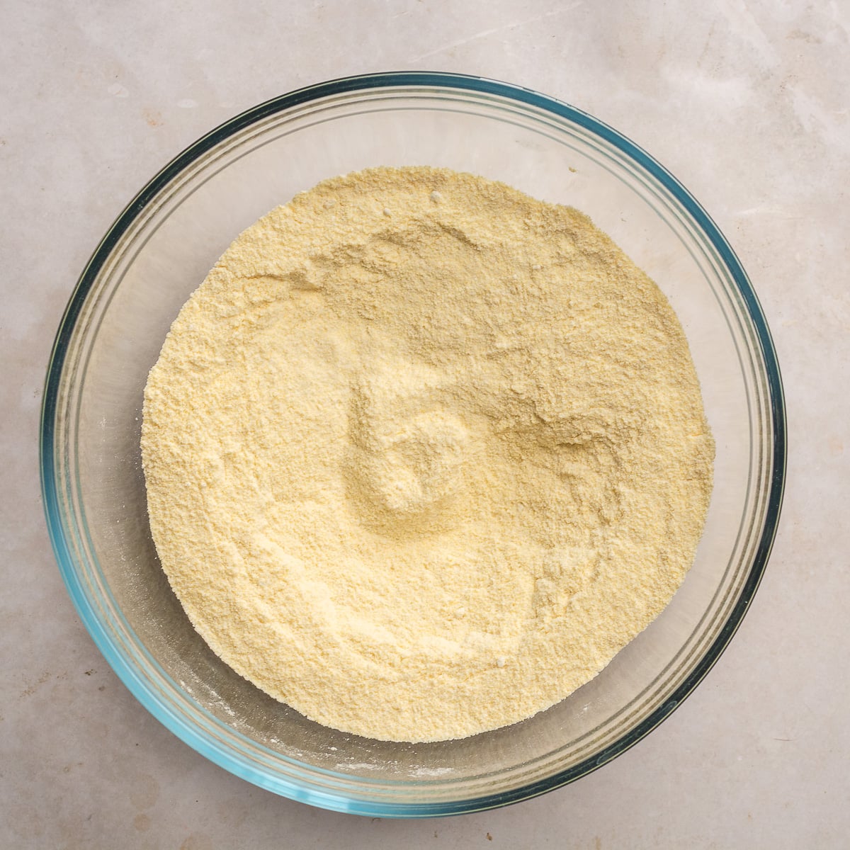 dry ingredients for blueberry cornbread mixed in glass bowl.