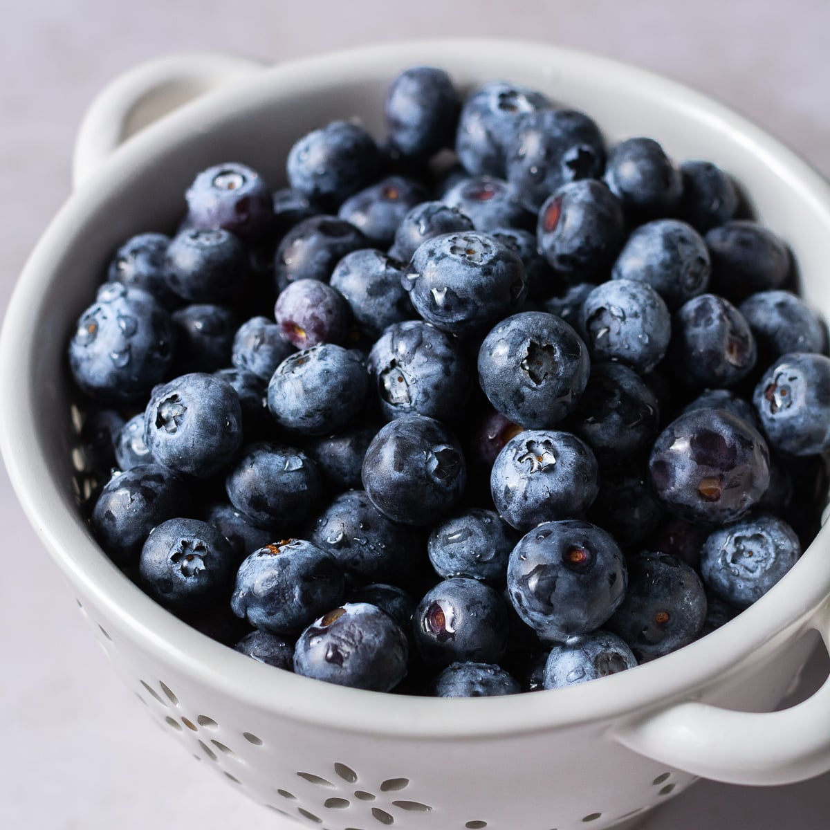 rinsed blueberries in a ceramic colander.