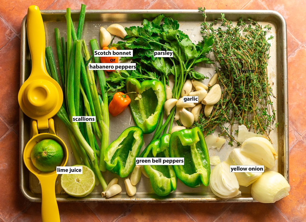 ingredients for Jamaican green seasoning - scallions, thyme, parsley, garlic, bell pepper, Scotch bonnet pepper, lime juice, yellow onion.