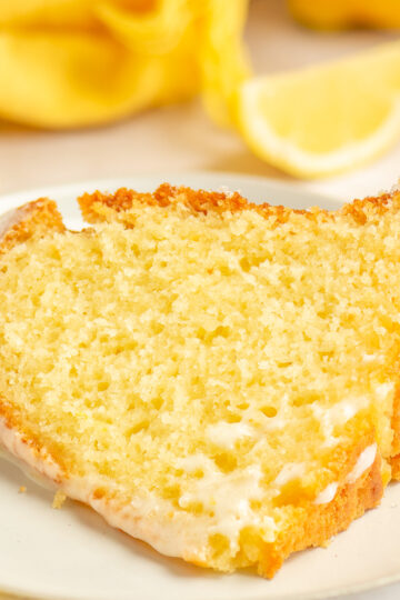 slice of lemon yogurt bundt cake on a plate.