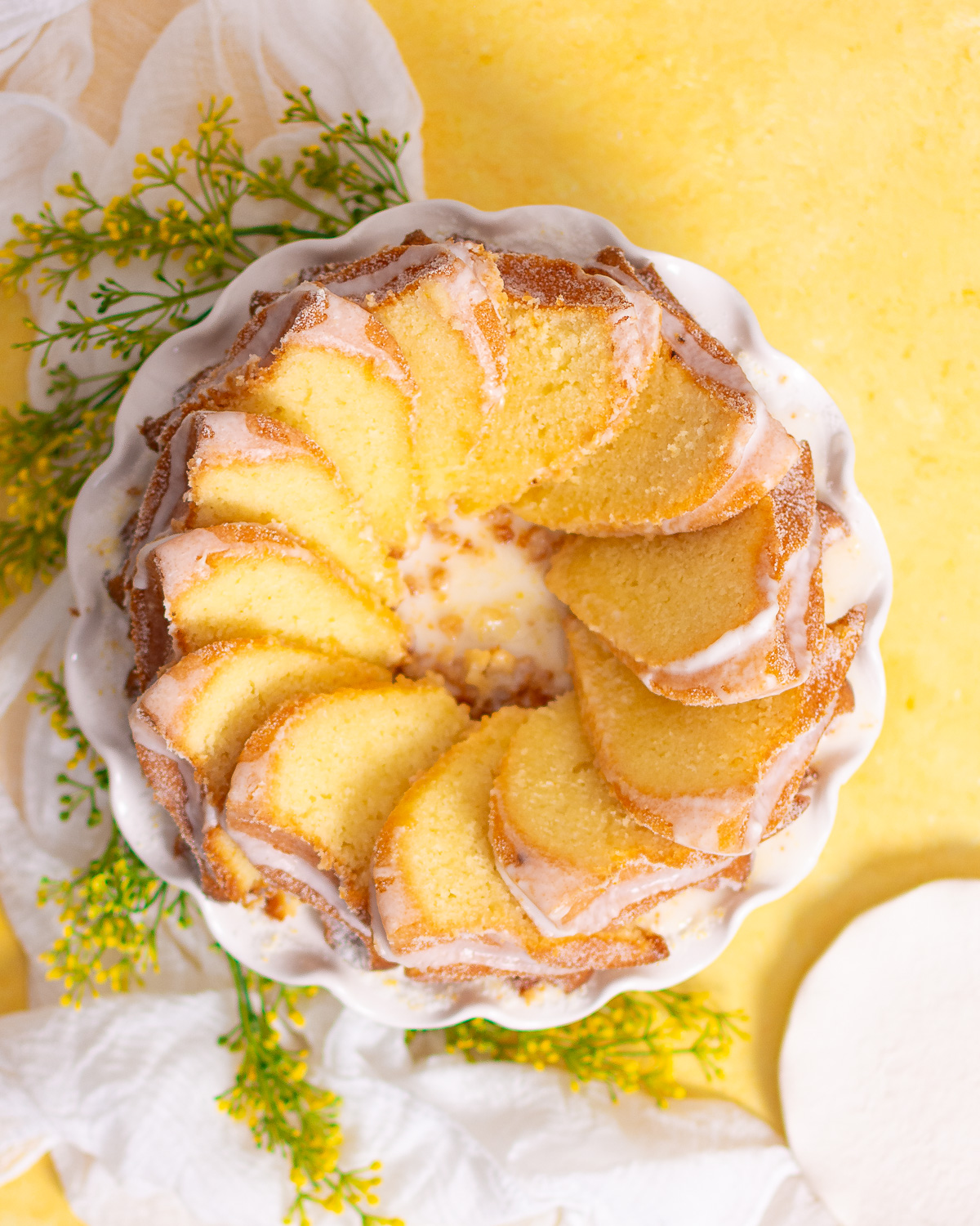 sliced lemon yogurt bundt cake on a cake stand