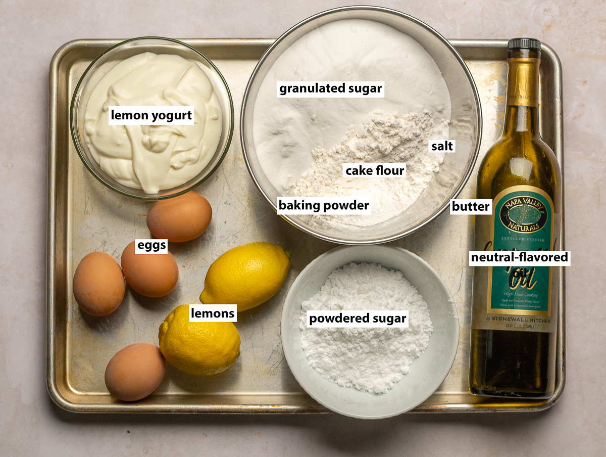 ingredients for lemon yogurt bundt cake - lemons, lemon yogurt, eggs, cake flour, granulated sugar, confectioner's sugar, oil, baking powder, salt.