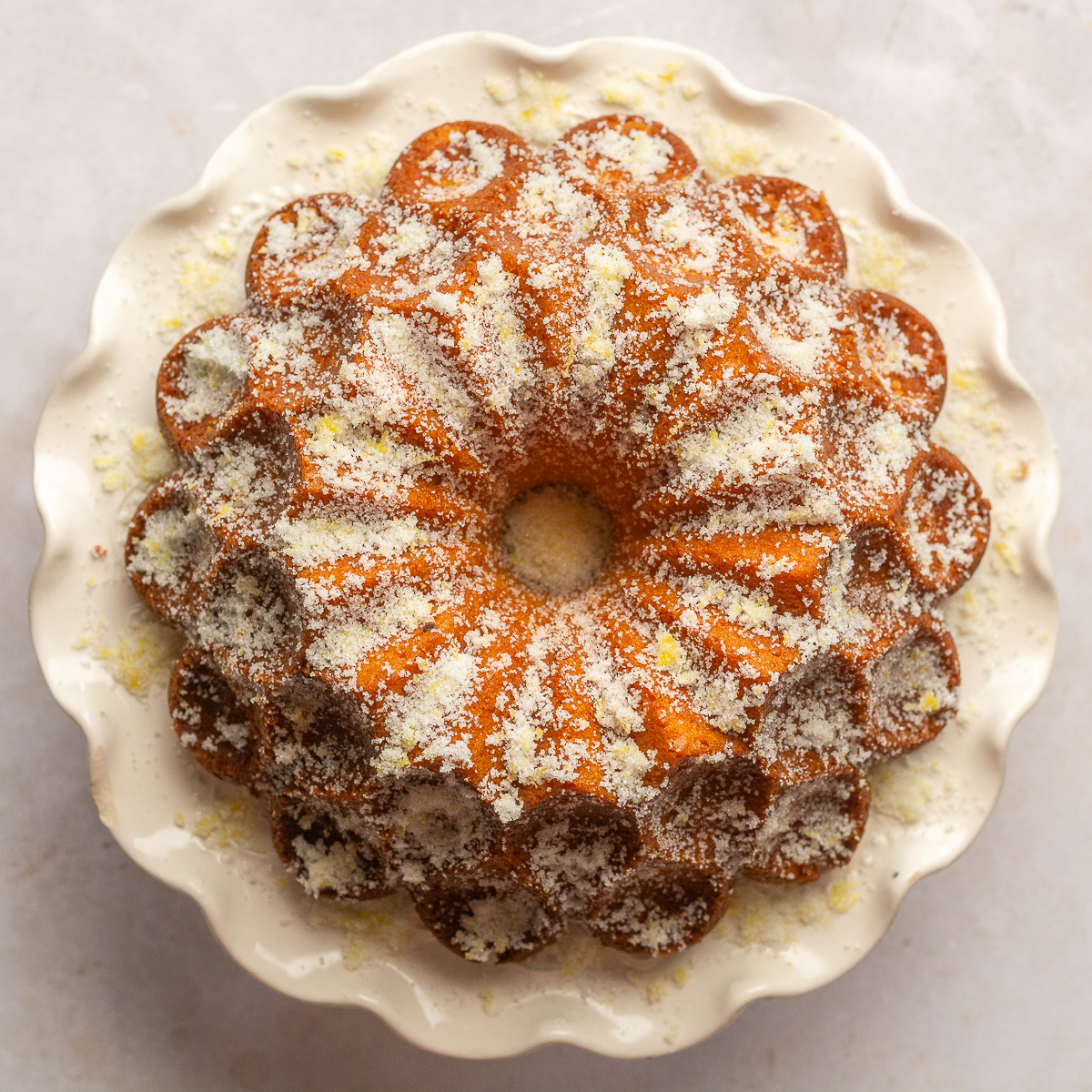 lemon yogurt bundt cake sprinkled with lemon sugar.