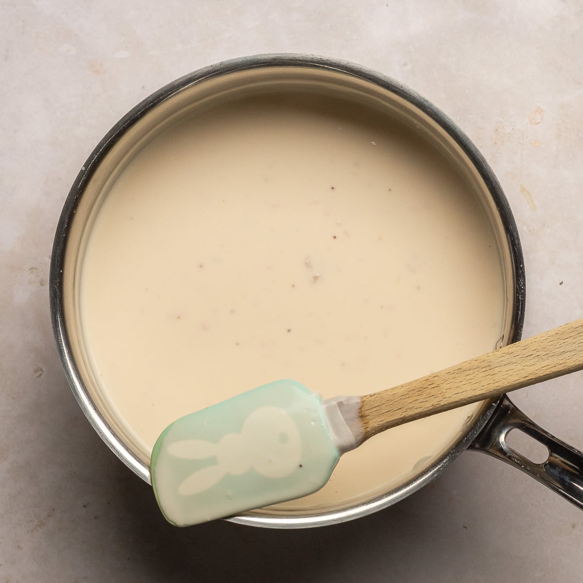 mixture of heavy cream, milk, sugar and strawberry cream cheese after heating on the stove.