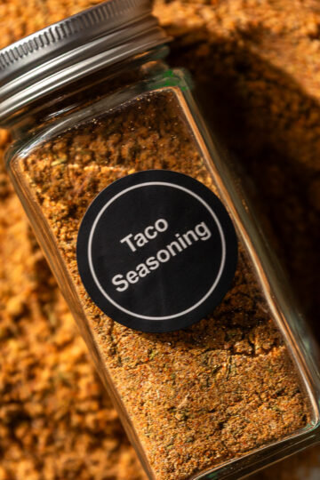 filled spice jar with "taco seasoning" label.
